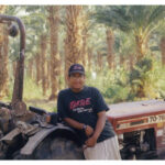 Teen Posing with a Tractor